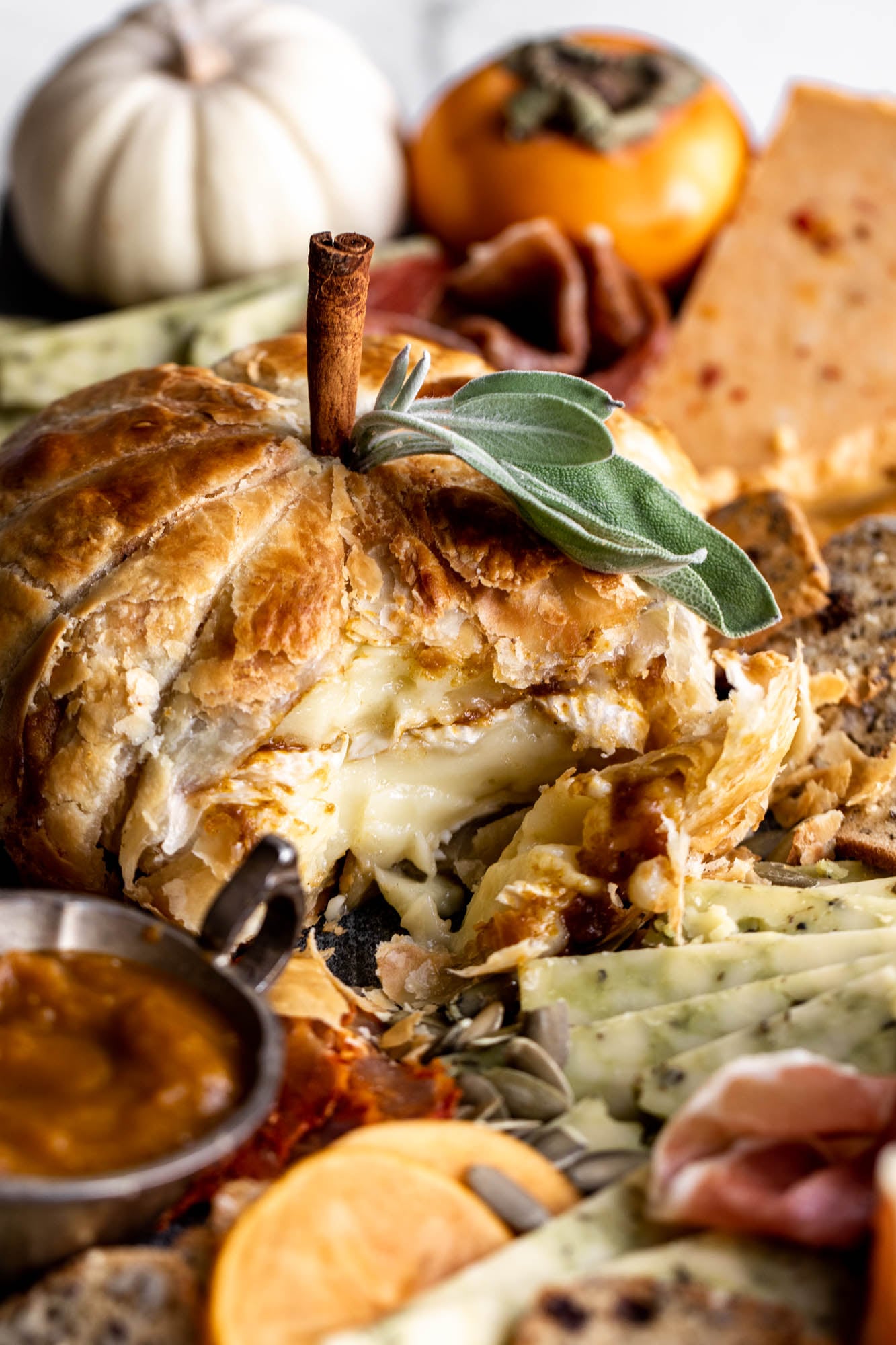 baked brie pumpkin with spiced maple butter cut.