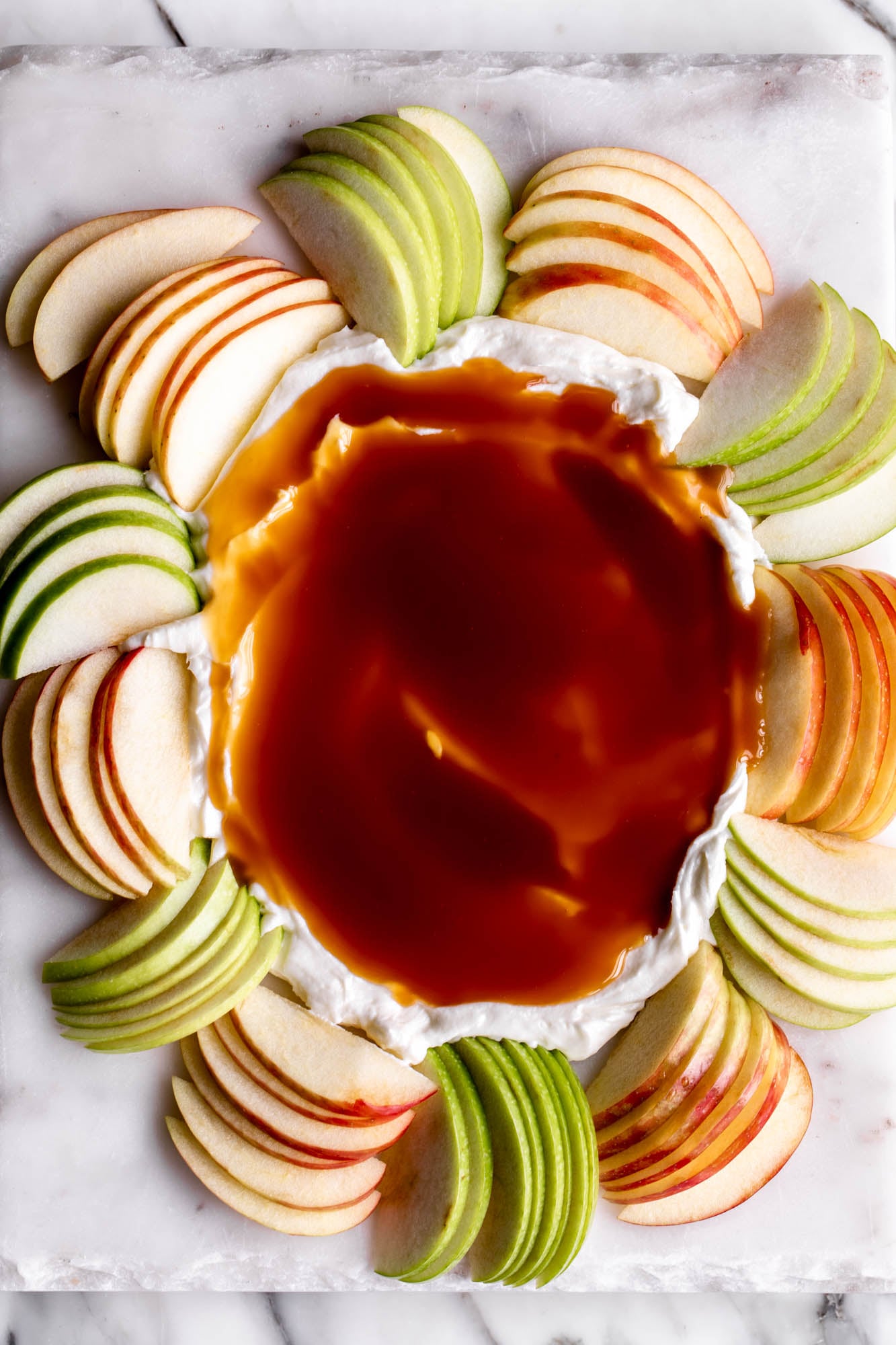 caramel apple dip with cream cheese and sliced apples.