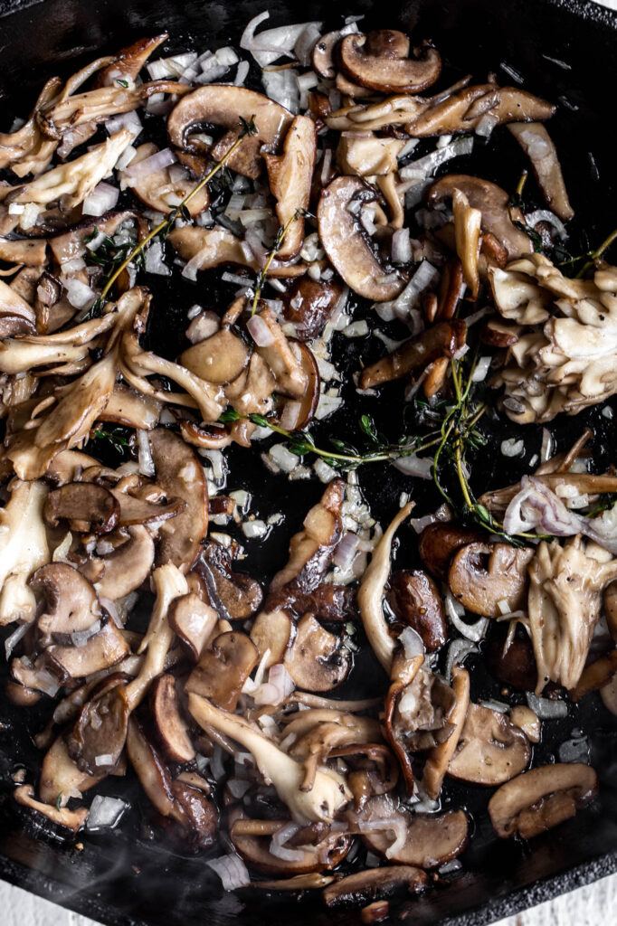 sautéed mushrooms with shallots and thyme in cast iron pan
