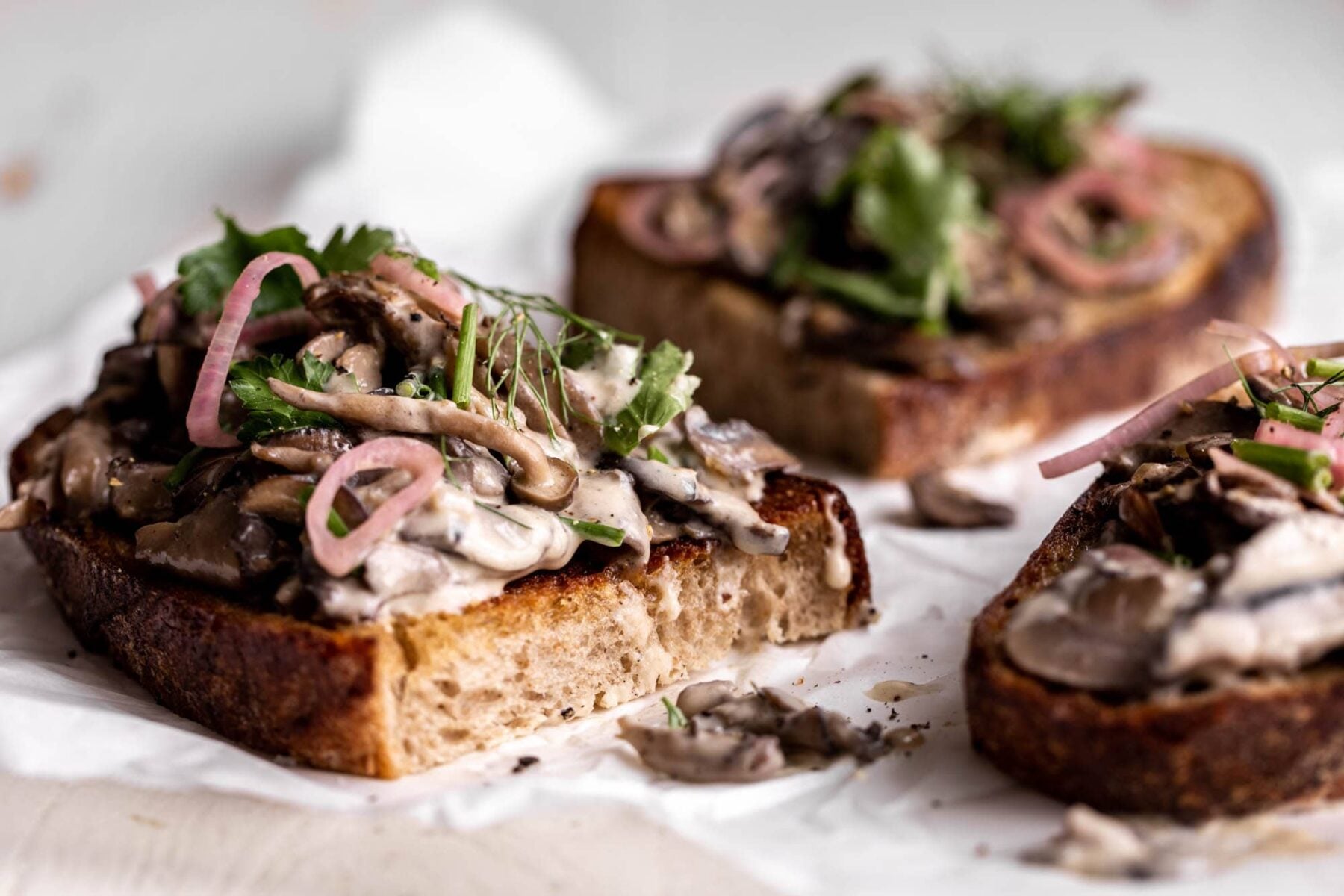 creamy mushroom toast with creme fraiche shallots and herbs.