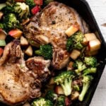 Pan-Seared Miso Butter Pork Chops with Sautéed Broccoli and Apples in cast iron.