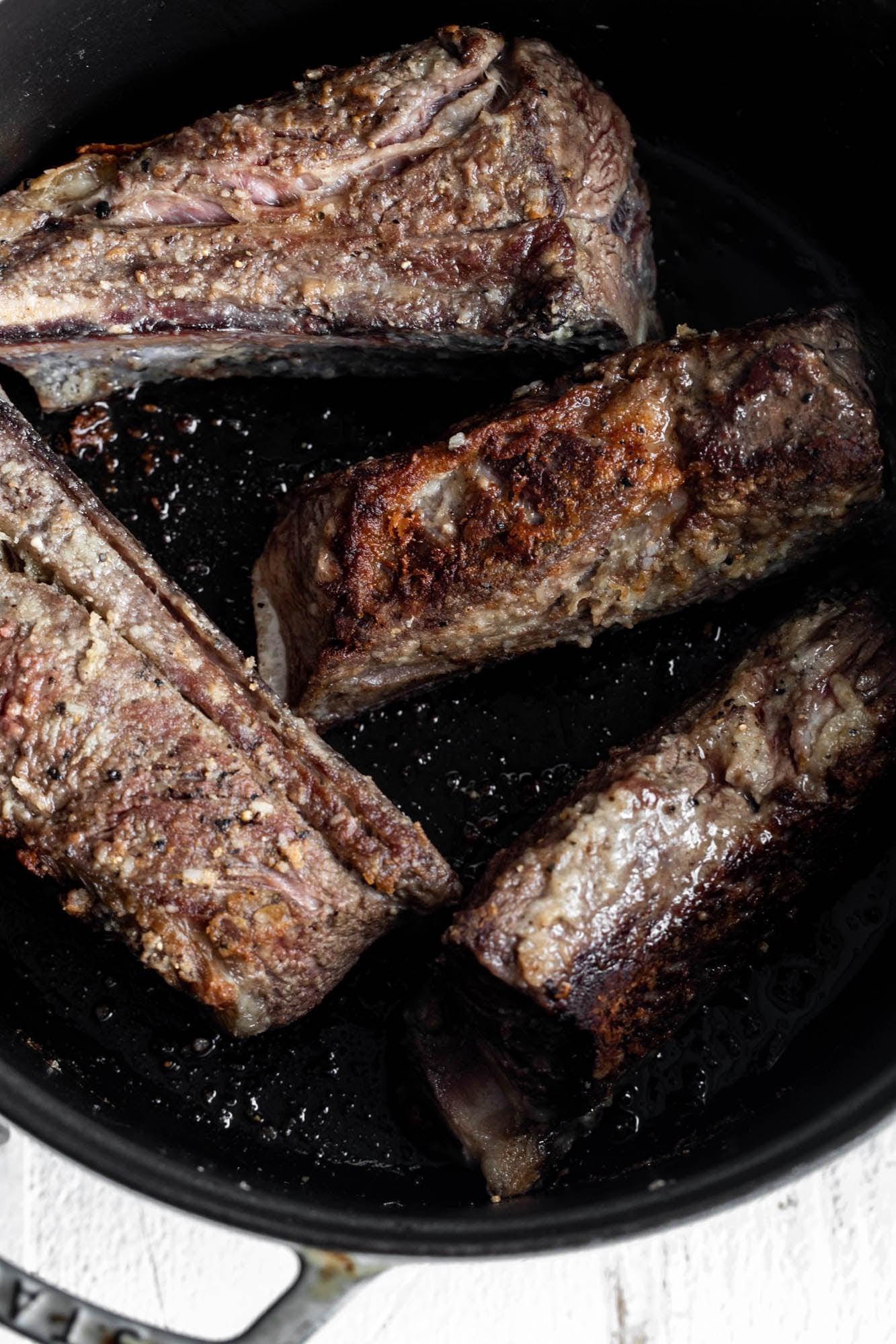 seared bone in short ribs in Dutch oven.