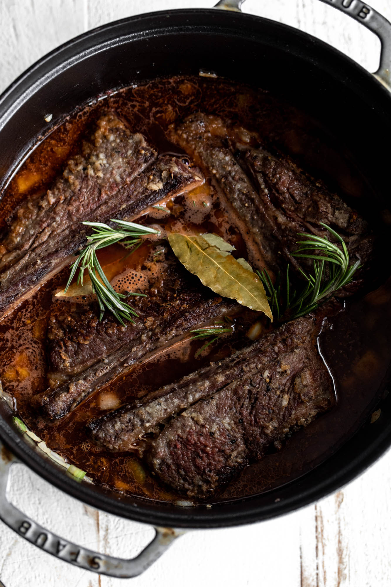 short ribs and braising liquid in dutch oven.