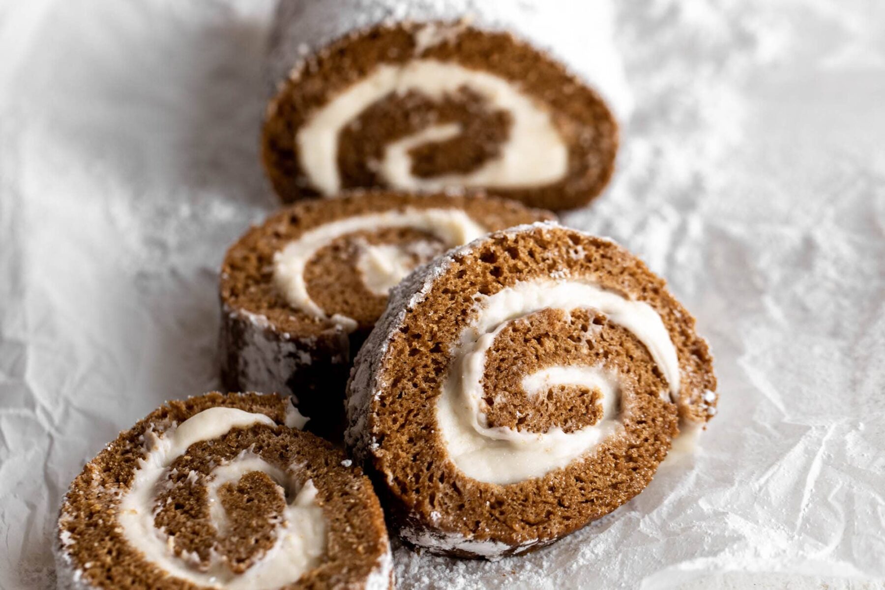 pumpkin roll with cream cheese frosting and powdered sugar.