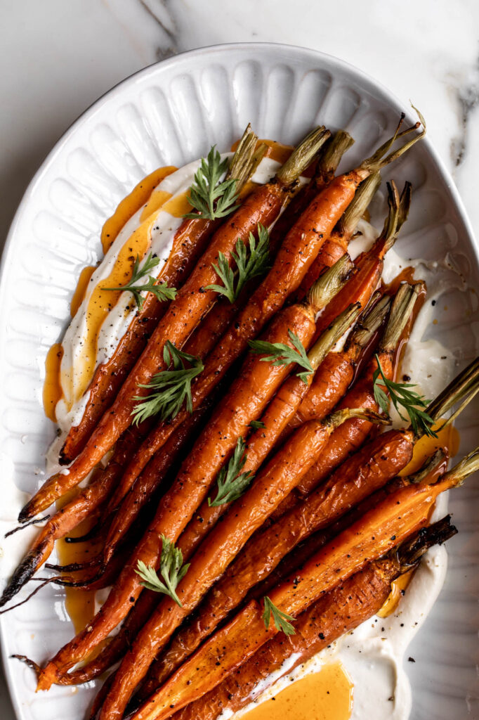 roasted carrots with chili butter and whipped ricotta on serving platter