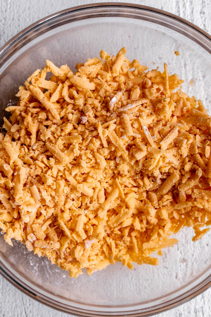 shredded cheddar cheese tossed in cornstarch with spices.