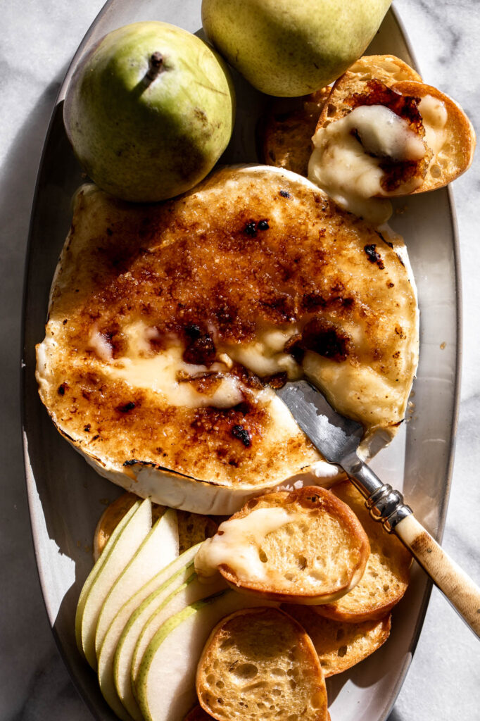easy appetizer brie brulee with cheese knife and crostini