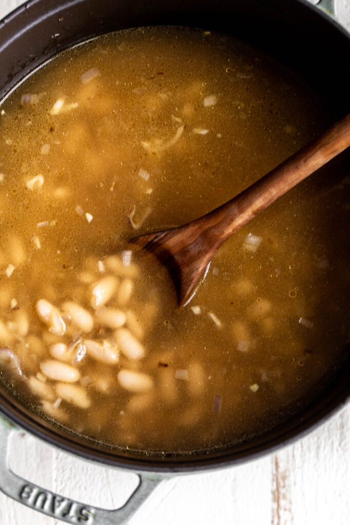 simmering soup on pot for creamy white bean soup