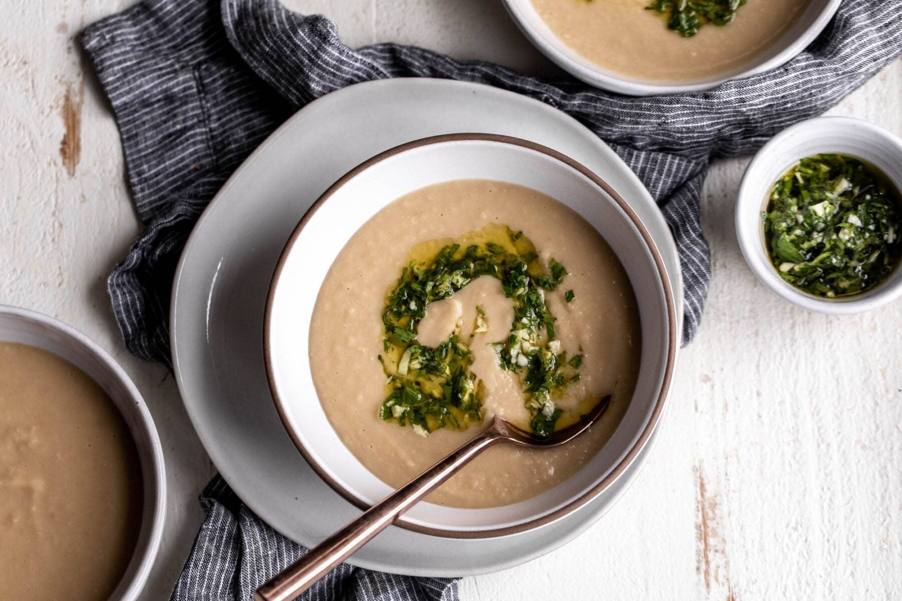 served creamy white bean soup with herb gremolata.