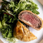 individual serving mini beef wellington cut in half medium rare.