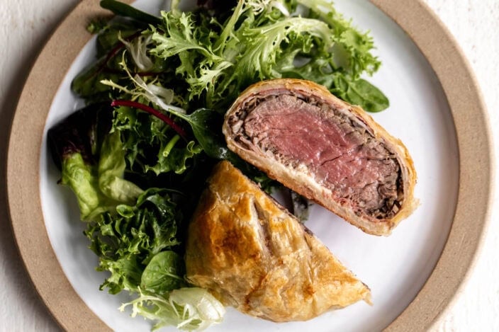 individual serving mini beef wellington cut in half medium rare.