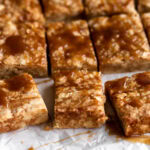 soy caramel shortbread cookie bars cut into squares.