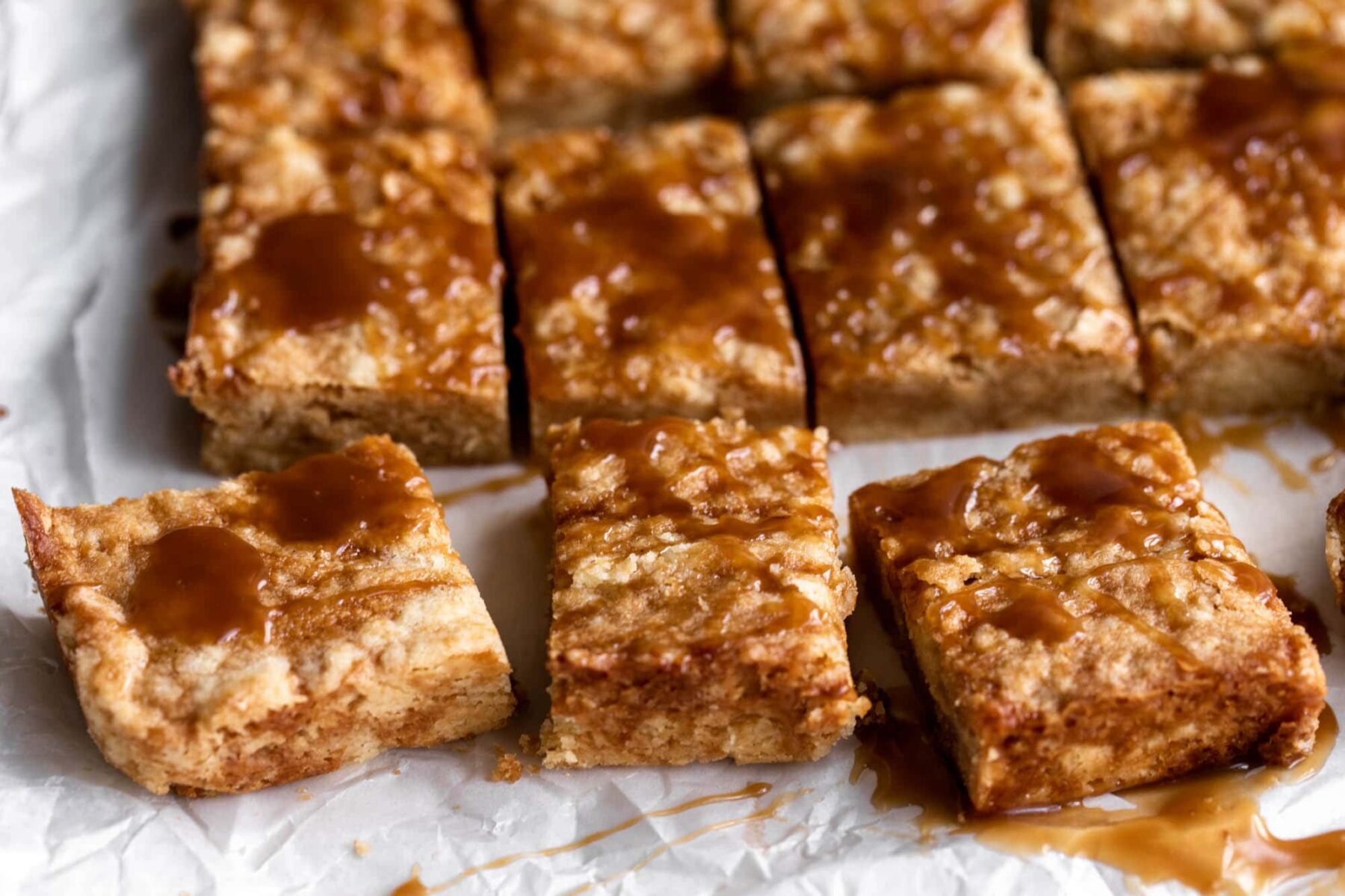 soy caramel shortbread cookie bars cut into squares.