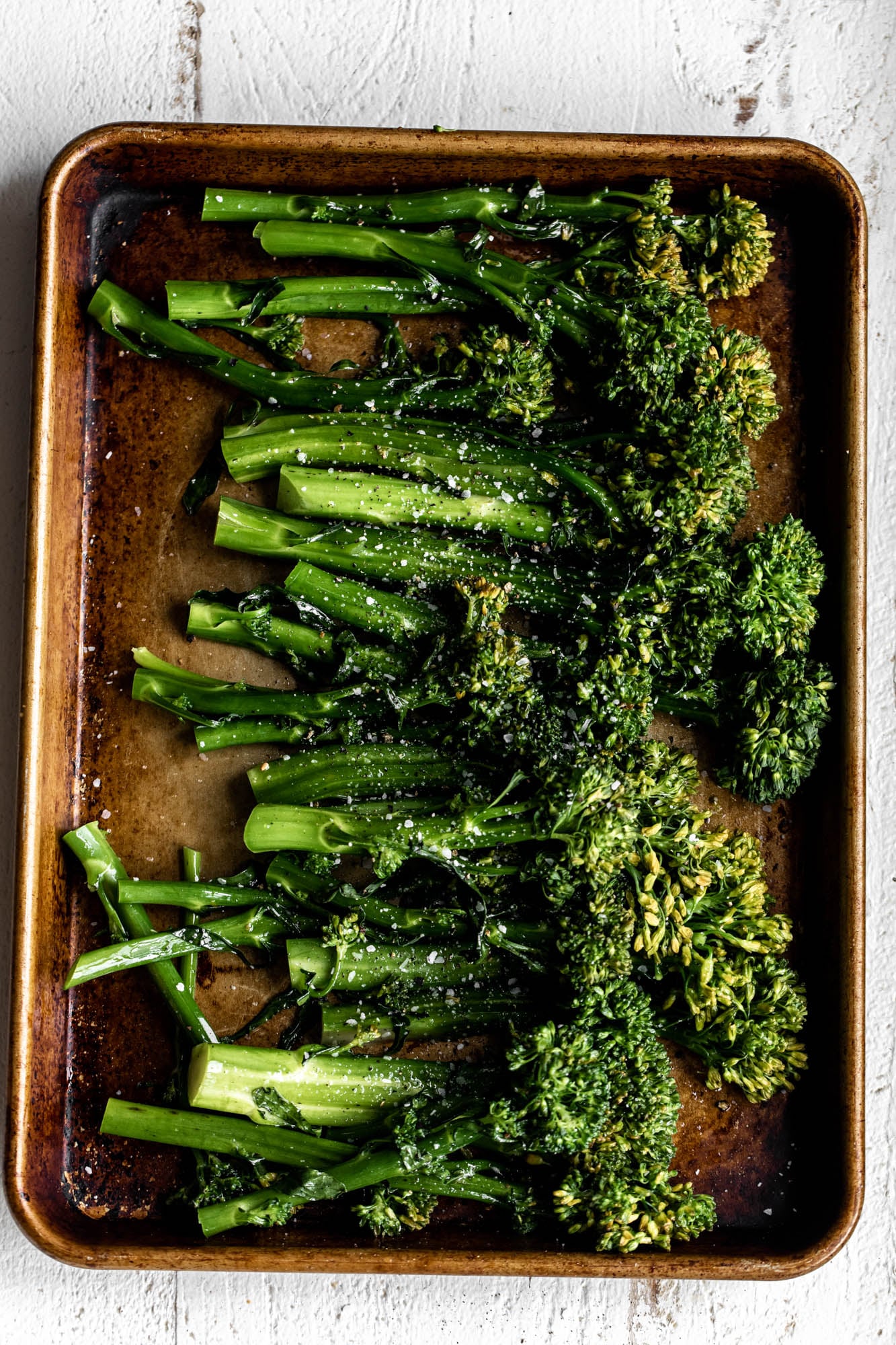 preparing Broccolini on baking sheet.