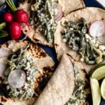 Creamy poblano tacos on corn tortillas with sliced radish.