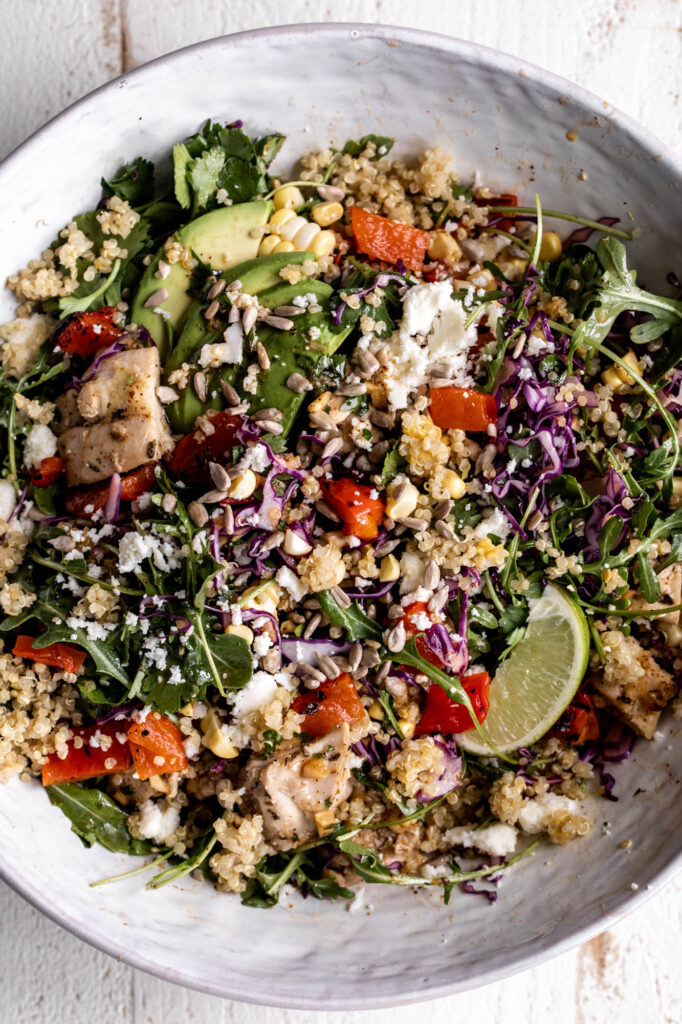 elote quinoa salad grain bowl with avocado and lime.