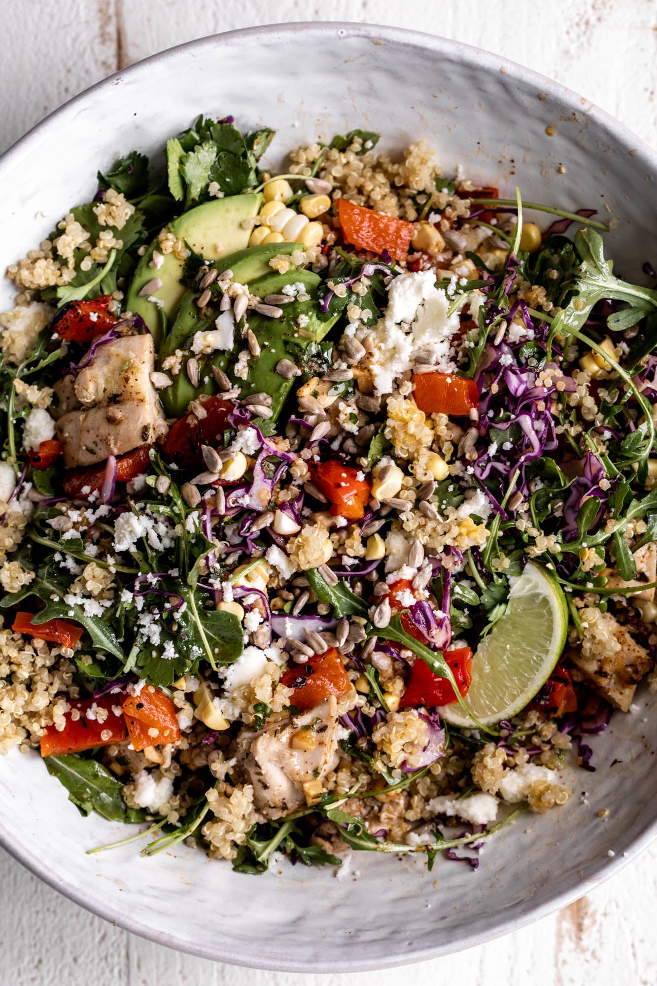 elote quinoa salad grain bowl with avocado and lime.