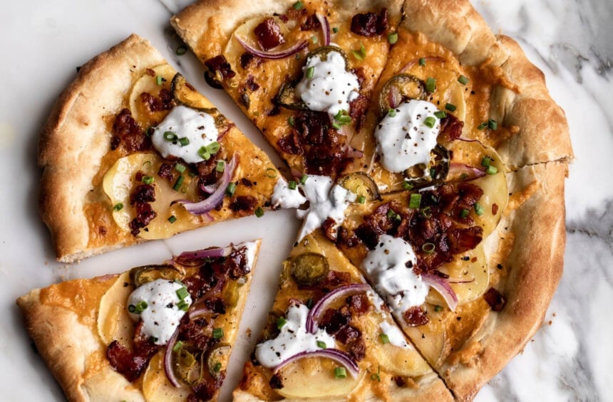loaded baked potato pizza with sour cream bacon and chives.