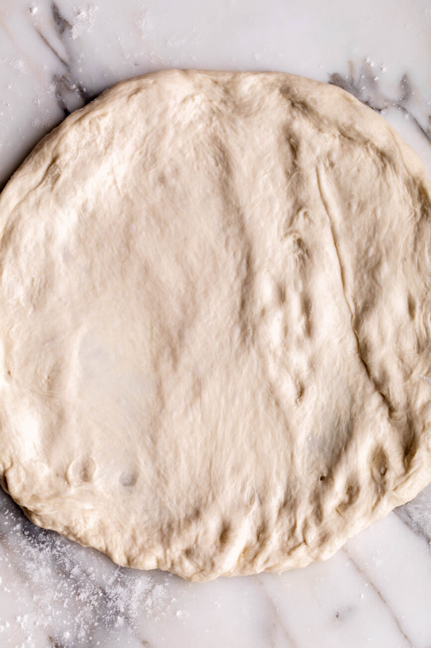 pressed out pizza dough ready for toppings.