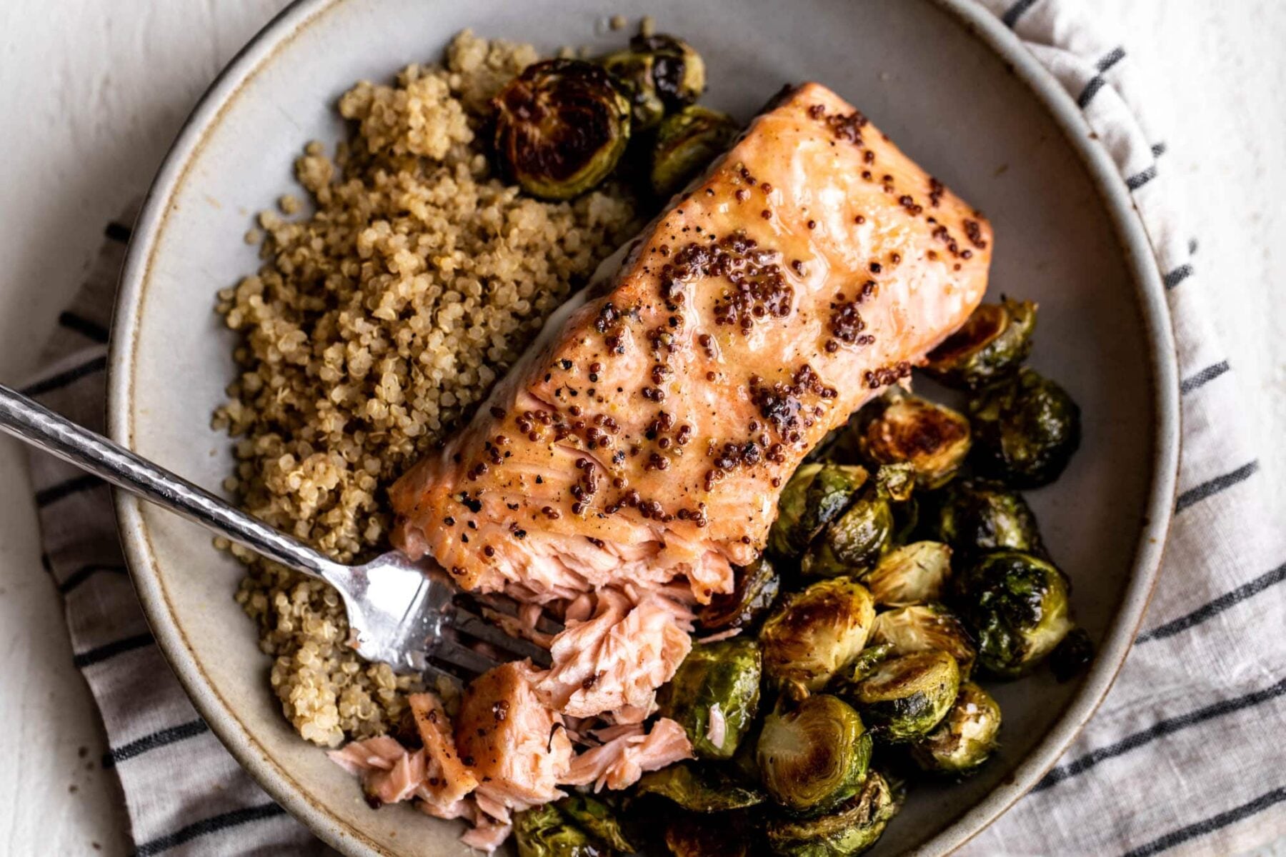 maple mustard salmon over quinoa and roasted brussels sprouts.