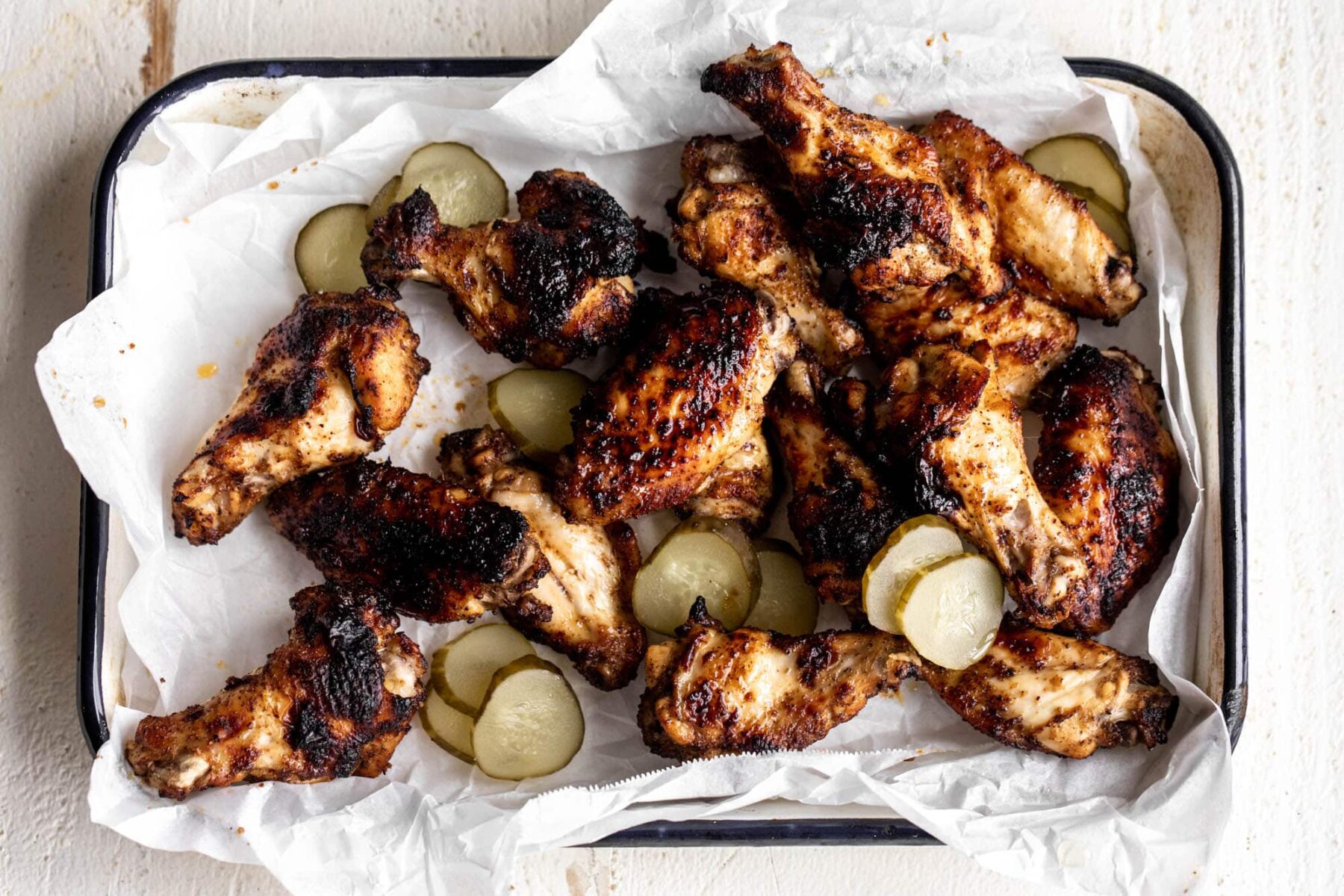 pickleback chicken wings with pickle slices.