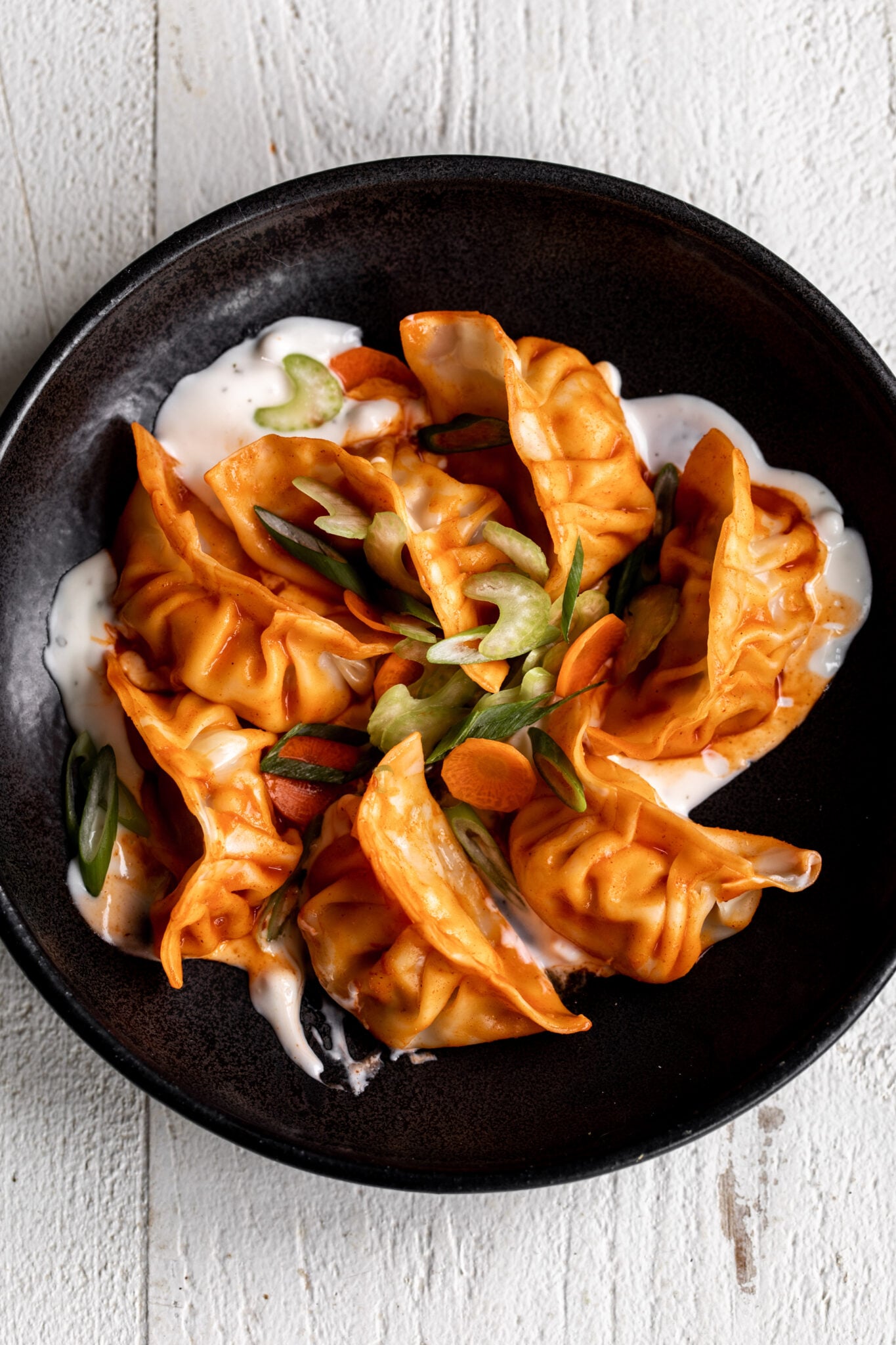 Buffalo chicken dumplings with celery and carrots and blue cheese dressing.