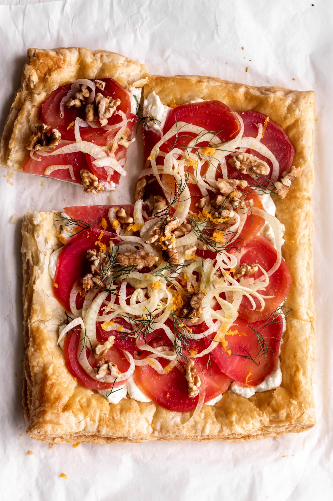 roasted beet and goat cheese tart with fennel slaw and pistachio on puff pastry.