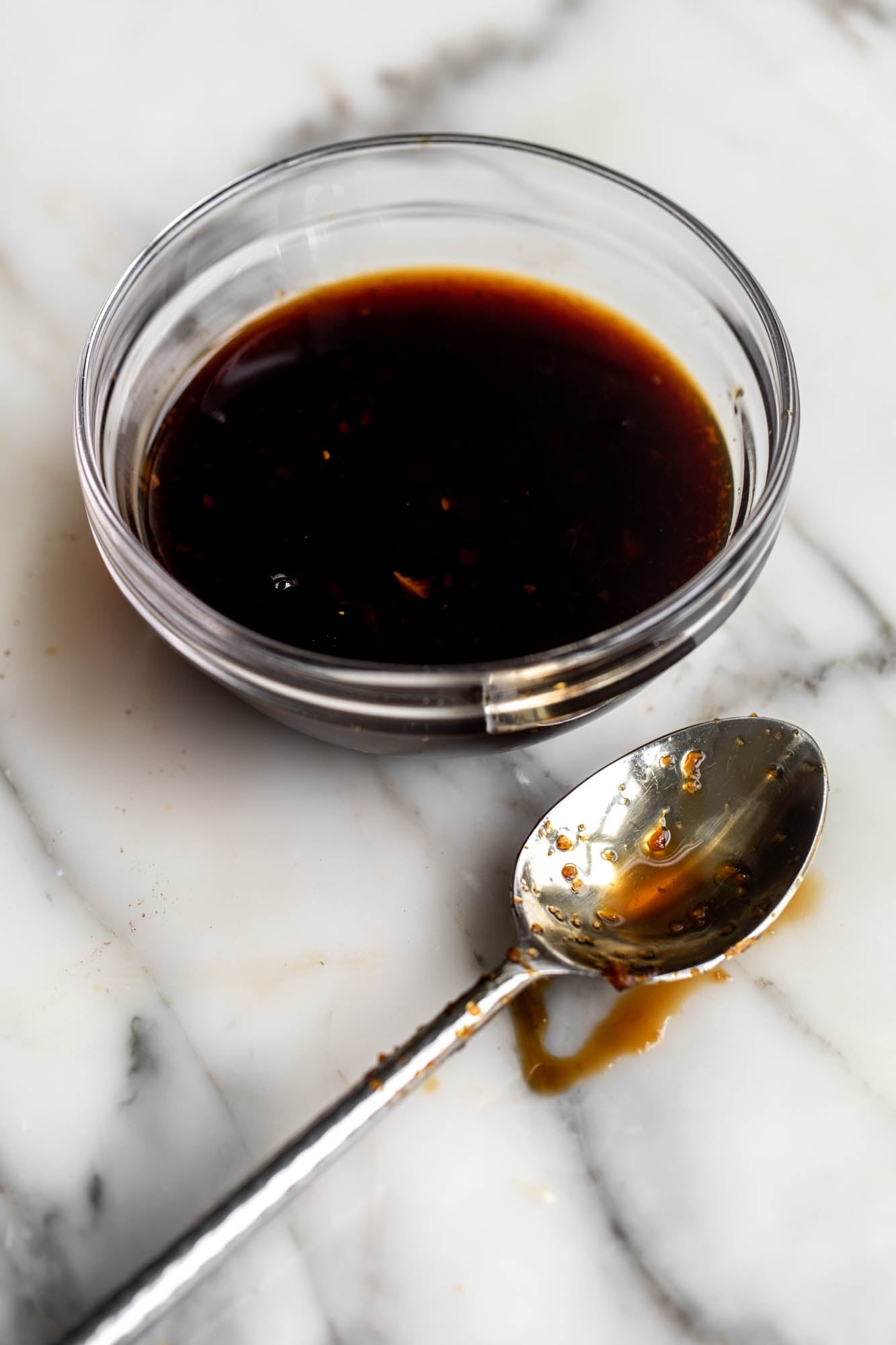 thickened teriyaki sauce in glass bowl with spoon.