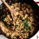 chimichurri rice with herbs in pot.