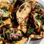 Crispy adobo mushroom tacos with avocado-tomatillo salsa and pickled onions on corn tortillas.
