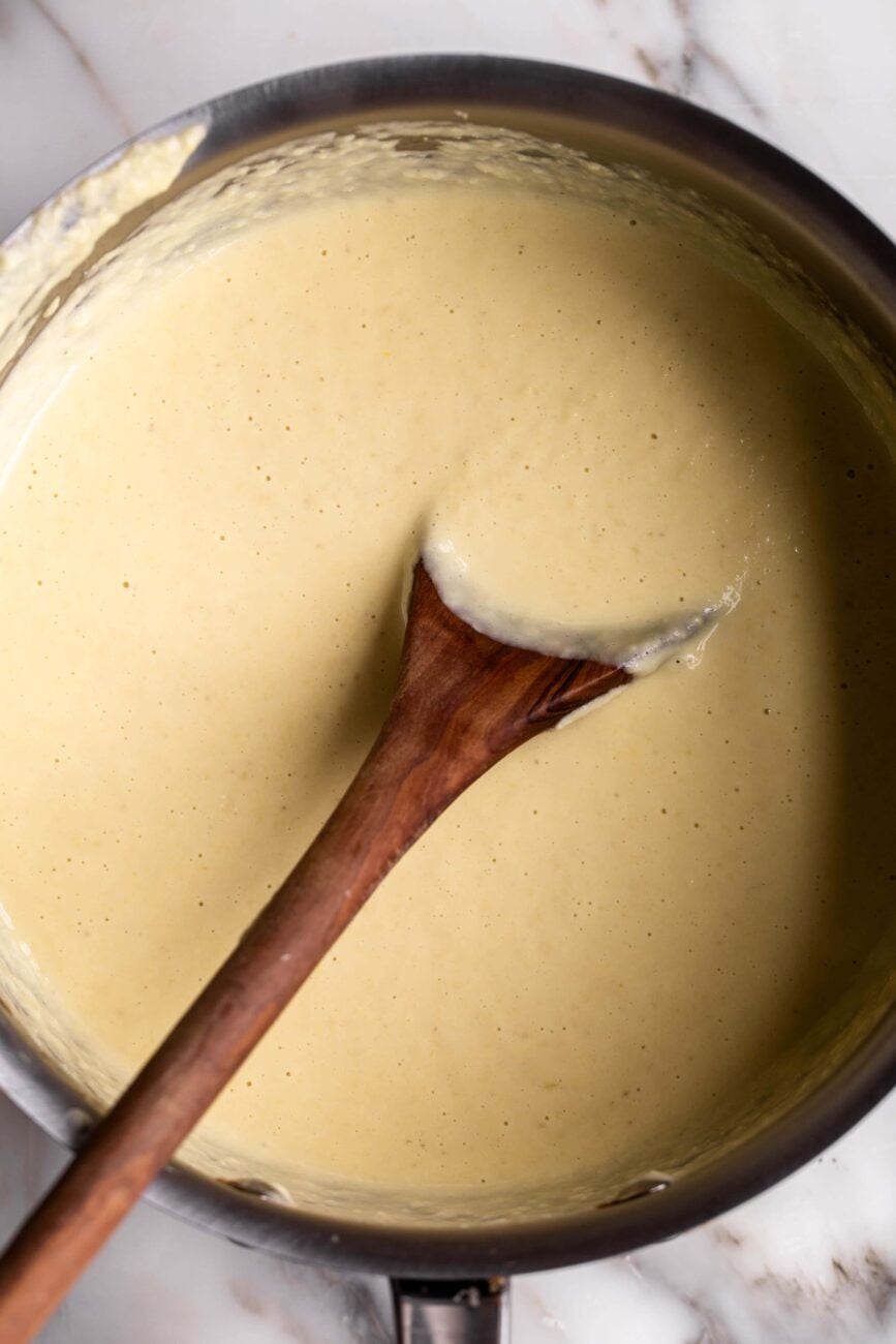 creamy corn pasta sauce in pot finished with cream.