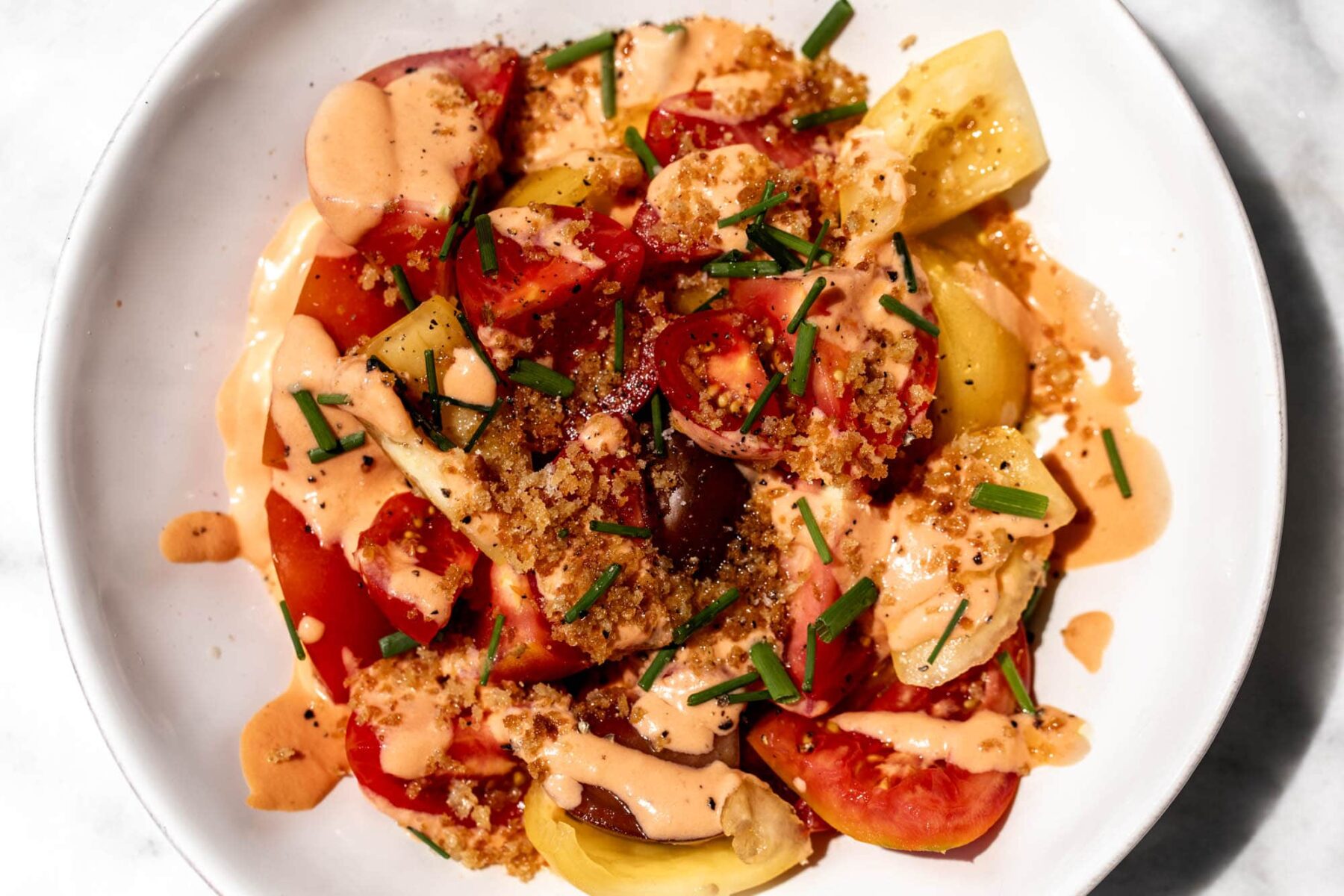 tomato salad with tomato buttermilk dressing and toasted breadcrumbs.