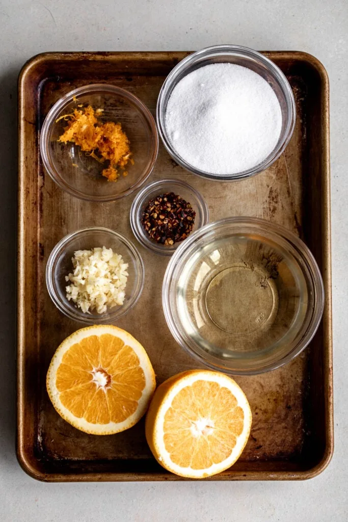 ingredients on tray to make homemade sweet chili sauce with orange.