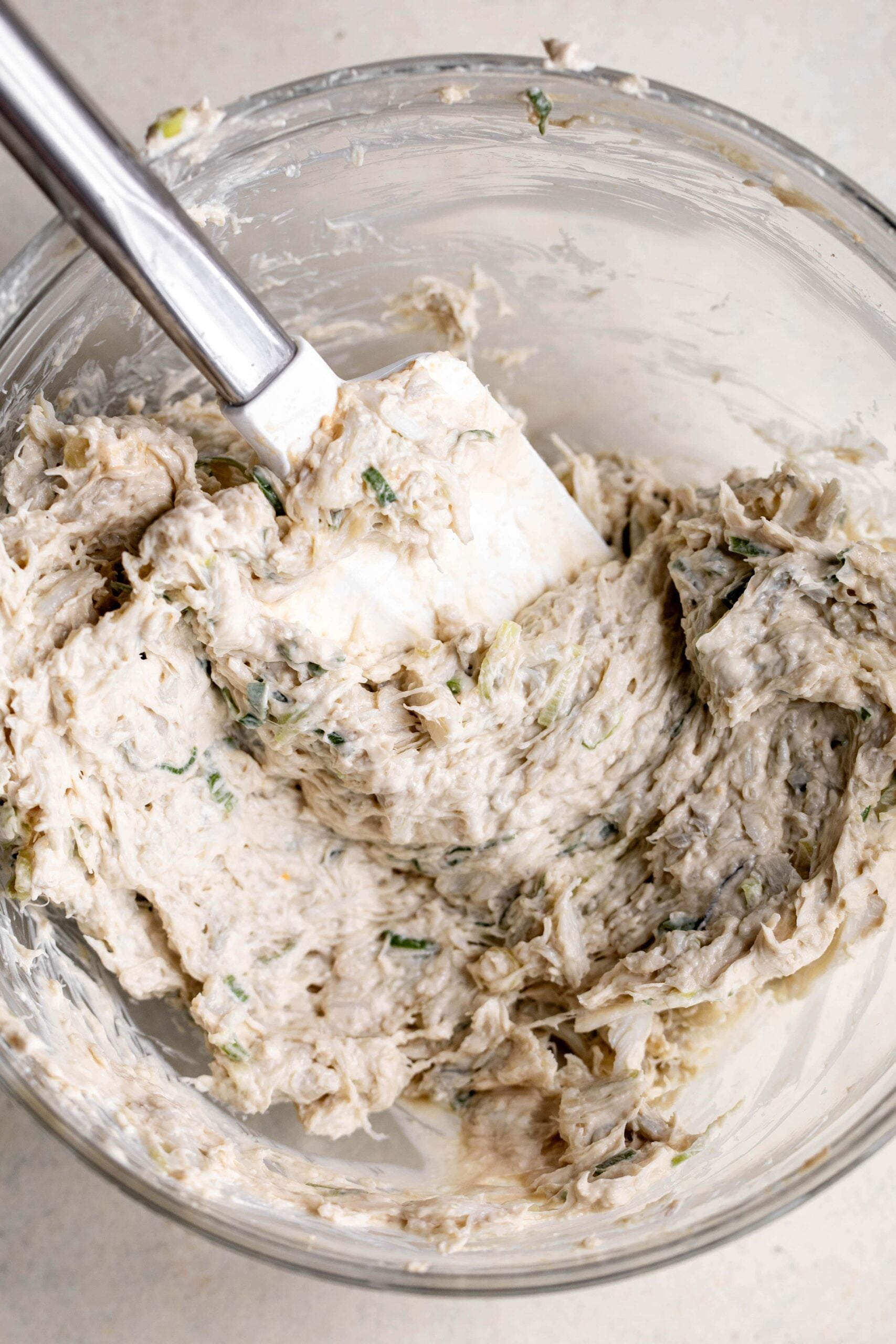 crab rangoon and cream cheese filling mixed in glass mixing bowl.