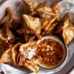 crab rangoons with orange sweet chili dipping sauce.