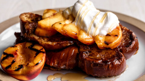 challah french toast with grilled peaches homemade whipped cream and honey