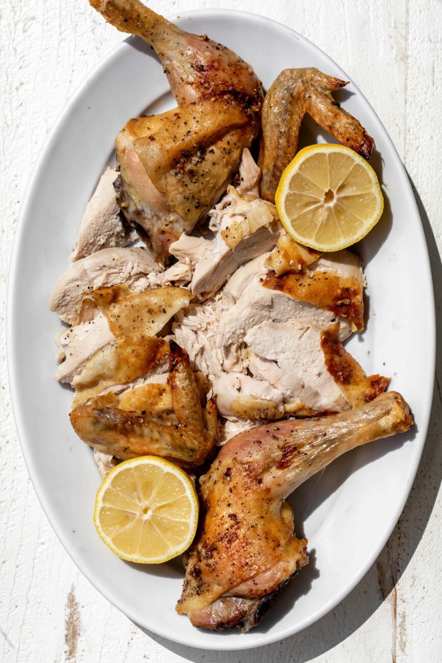 broken down roast spatchcocked chicken.