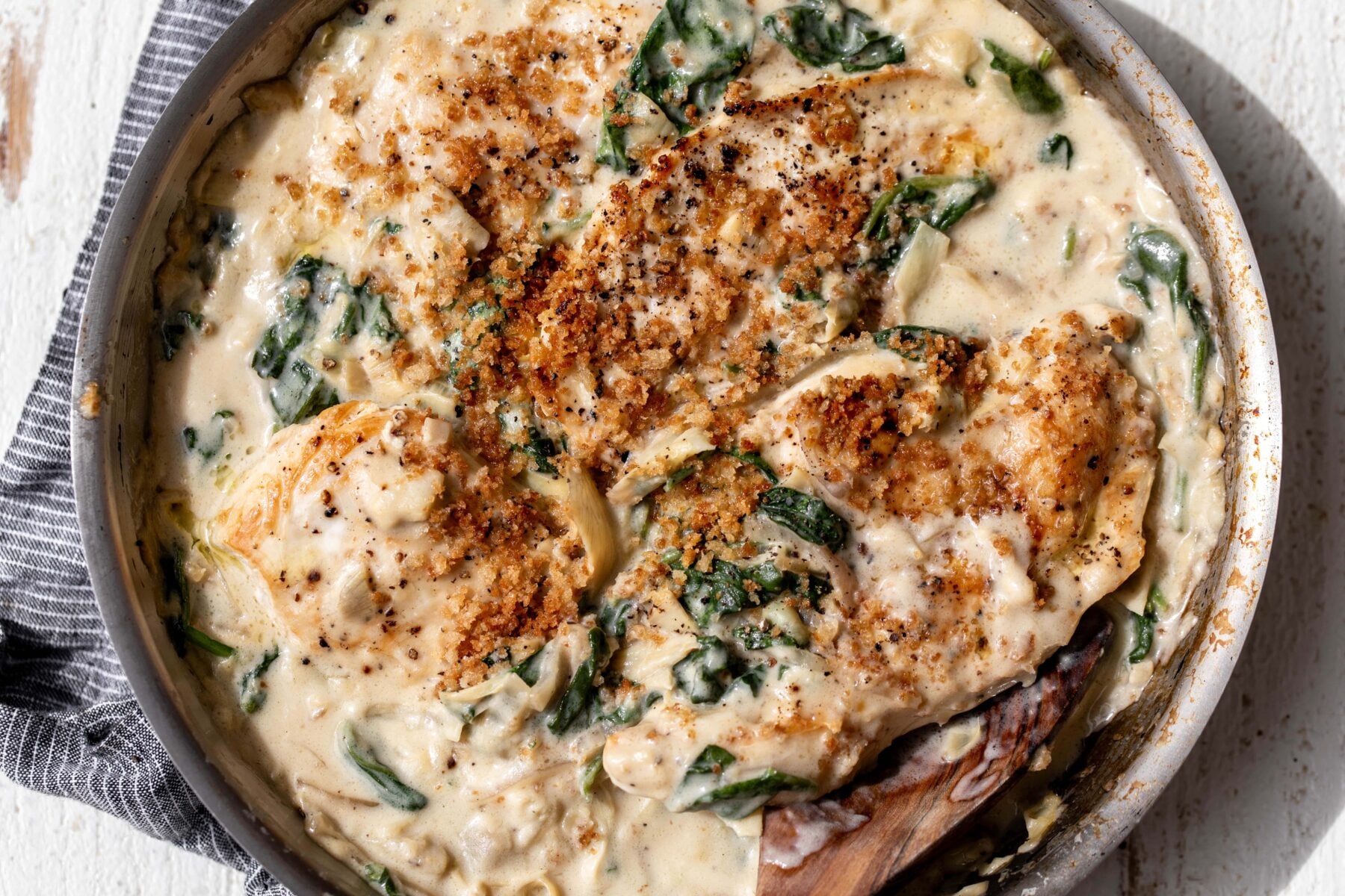 cheesy spinach artichoke chicken breasts with breadcrumb topping.