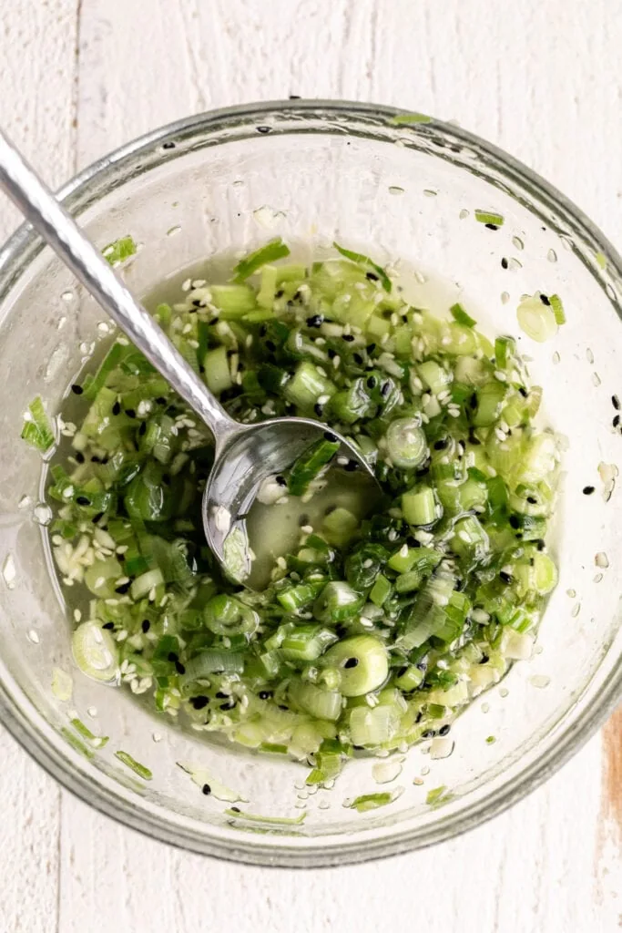 green onion garlic sauce in glass mixing bowl.