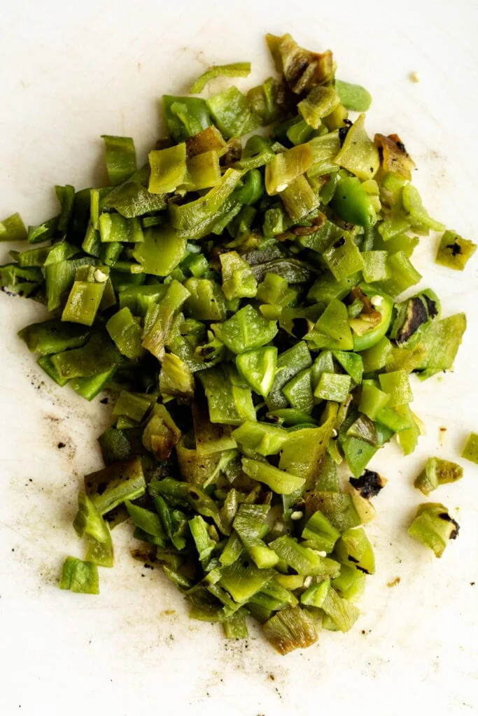 chopped seeded hatch peppers on white cutting board