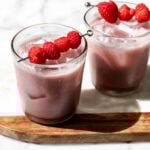 Coconut Hibiscus Refresher garnished with fresh raspberries.