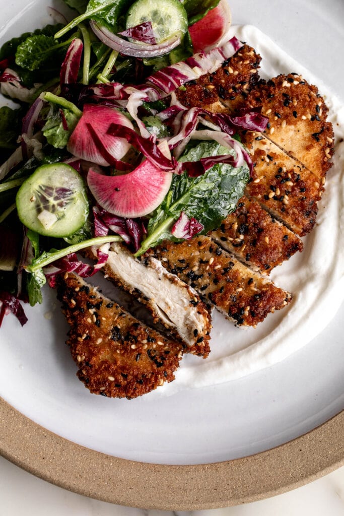 everything Bagel Chicken Cutlets garnished with green salad and radish.