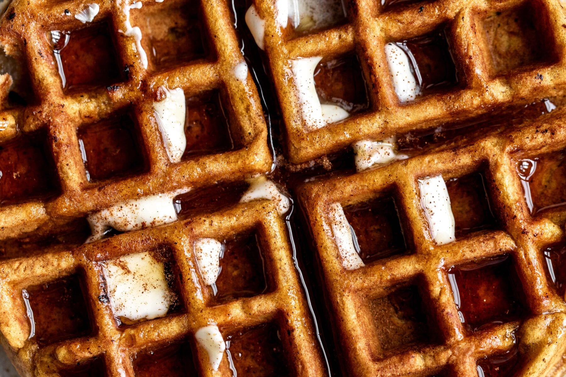 pumpkin waffles with cream cheese filling with butter and maple syrup.