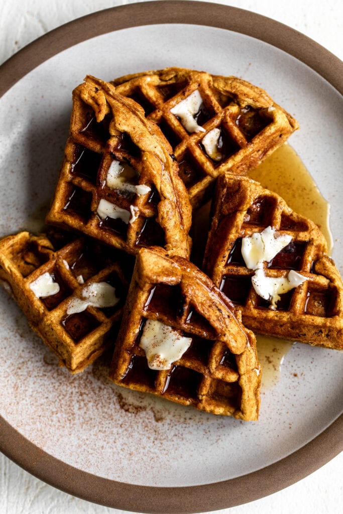 plate of pumpkin waffles with cream cheese filling.