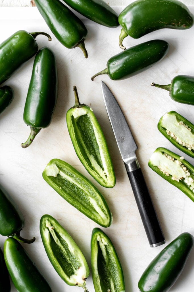 sliced scooped jalapeños with pairing knife.