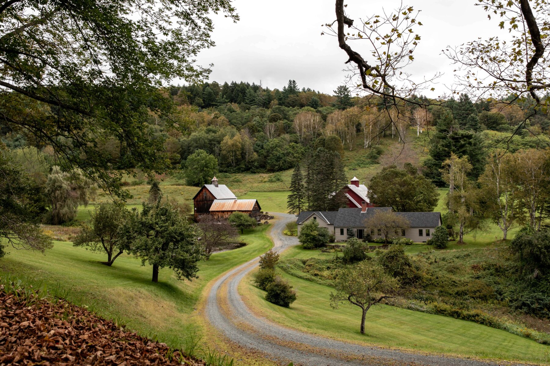woodstock vermont greenery with house and barn in the fall.