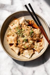 pork wontons with peanut sauce and chili oil.