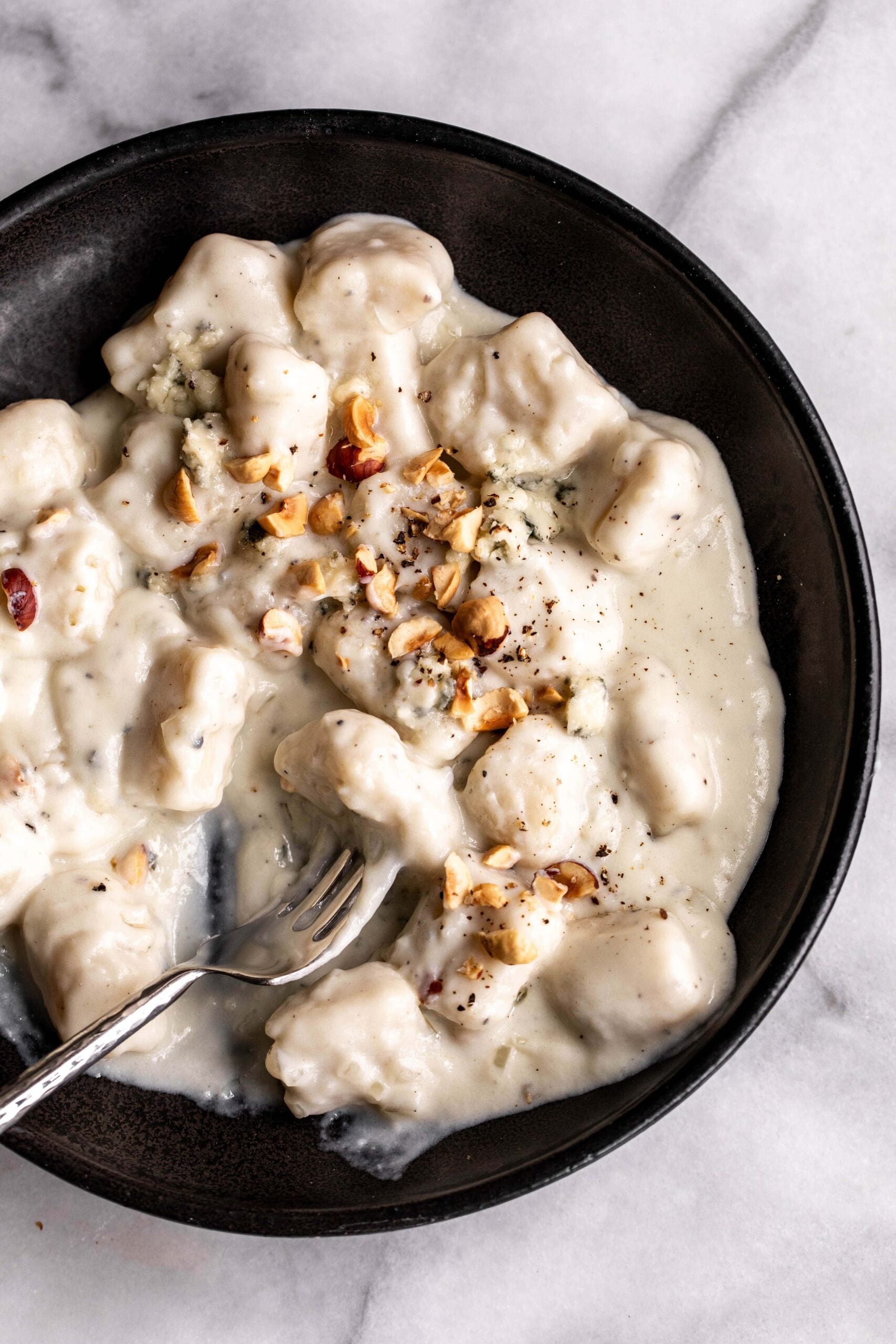 bowl of potato gnocchi in blue cheese cream sauce.