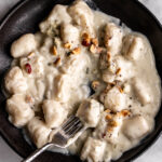 potato gnocchi in blue cheese cream sauce topped with hazelnuts.