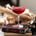 Vampire kiss halloween cocktail with red gel garnish.